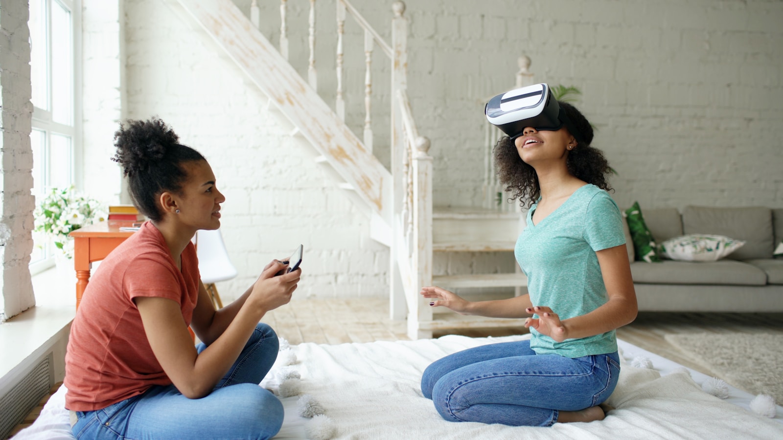 Two young women experiencing virtual reality together
